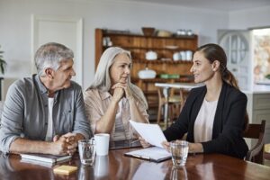 an older couple speaking with their lawyer at their kitchen table about florida domicile